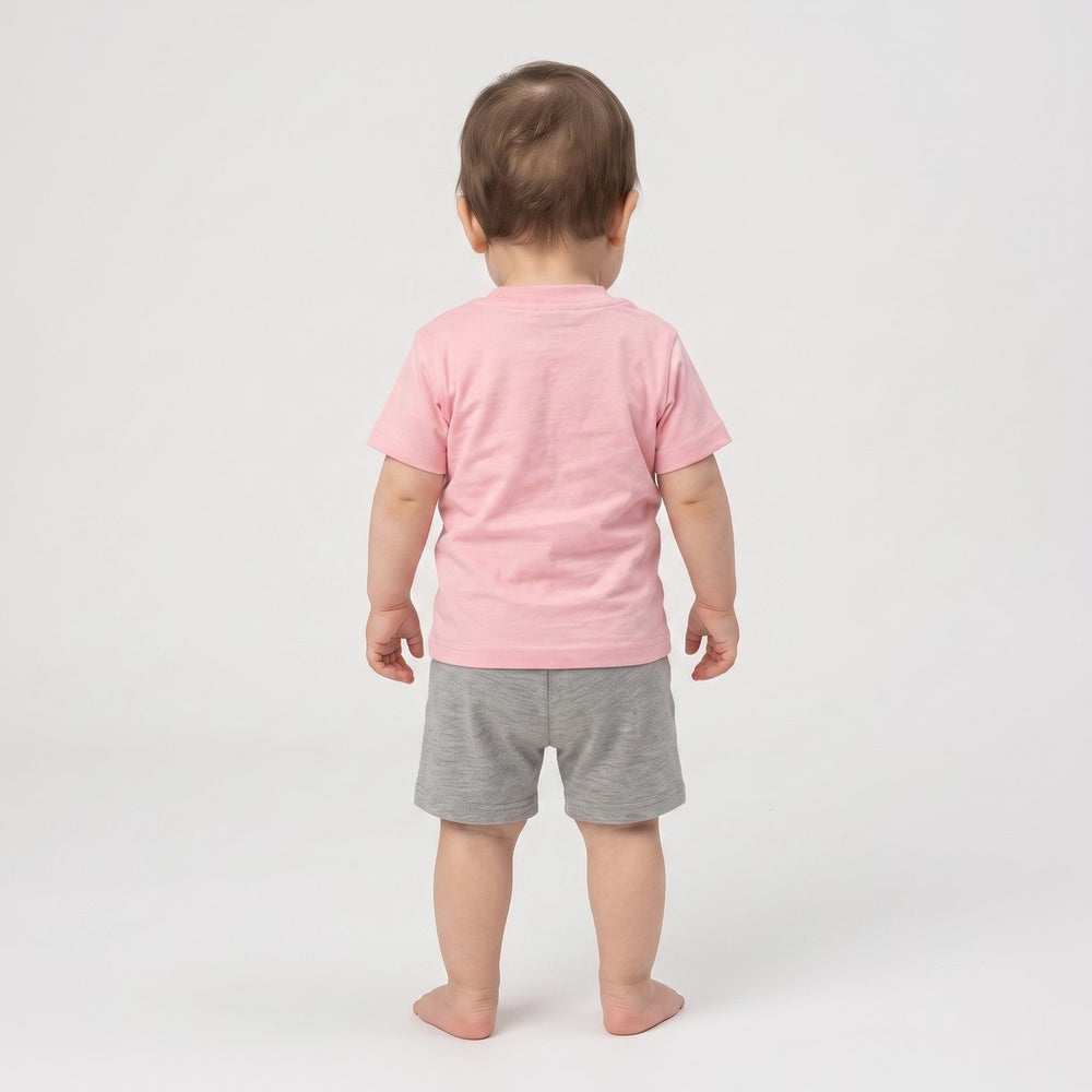 Baby 5 T-Shirt Pink. Back view of an infant wearing a plain pink short-sleeve t-shirt made from soft jersey knit fabric.
