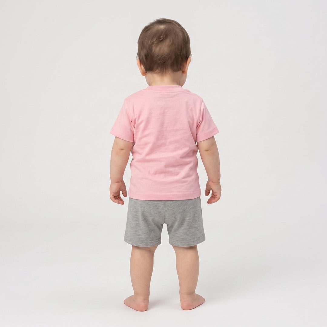 Baby 5 T-Shirt Pink. Back view of an infant wearing a plain pink short-sleeve t-shirt made from soft jersey knit fabric.