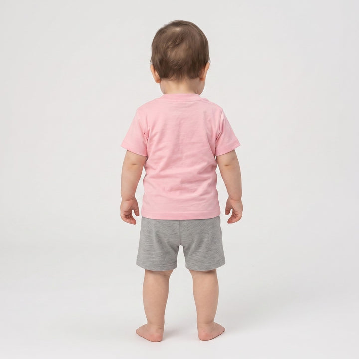Baby 5 T-Shirt Pink. Back view of an infant wearing a plain pink short-sleeve t-shirt made from soft jersey knit fabric.