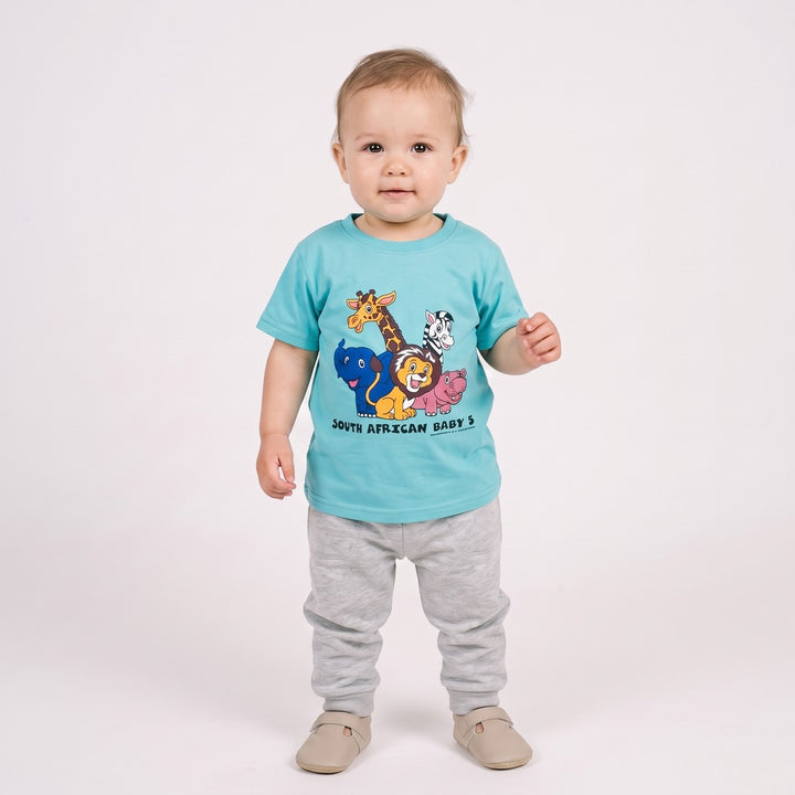 Baby 5 T-Shirt in turquoise, shown full body on an infant, featuring a vibrant cartoon safari animal print.
