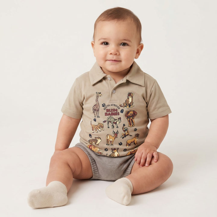 Bushbaby Golfer Stone infant short-sleeve polo shirt, featuring a vibrant South African safari animal print.