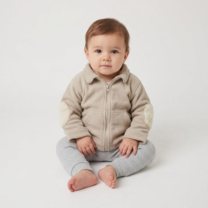 Beige fleece Bushbaby Track Top for infants, featuring a full zip closure, a collar, and cream-colored fleece elbow patches.