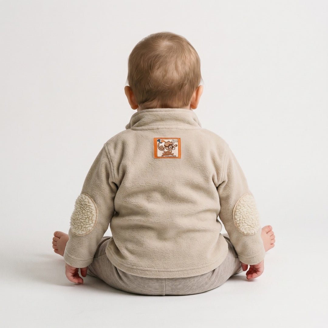 Beige Bushbaby Track Top for infants, made of soft fleece, visible from the back, featuring cream elbow patches and a unique