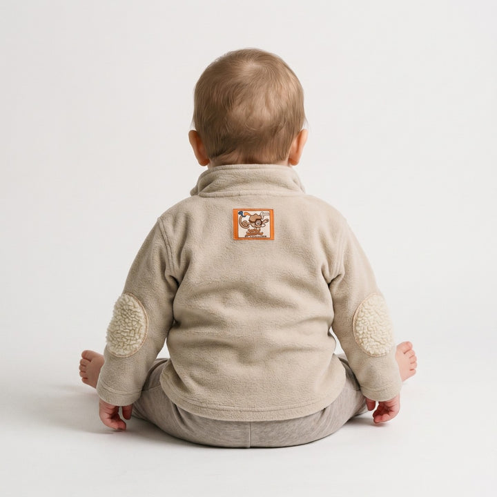 Beige Bushbaby Track Top for infants, made of soft fleece, visible from the back, featuring cream elbow patches and a unique