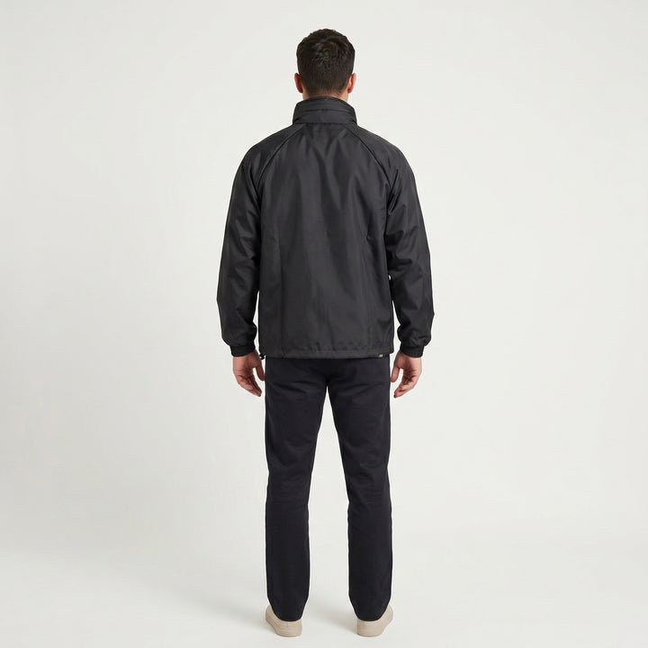 Back view of a black Drimac jacket, featuring a lightweight fabric, elasticized cuffs, and a drawstring hem for a