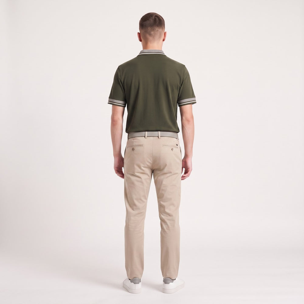 Back view of a male model wearing an olive Golfer Big 5 polo shirt with striped collar and cuffs, paired with light grey