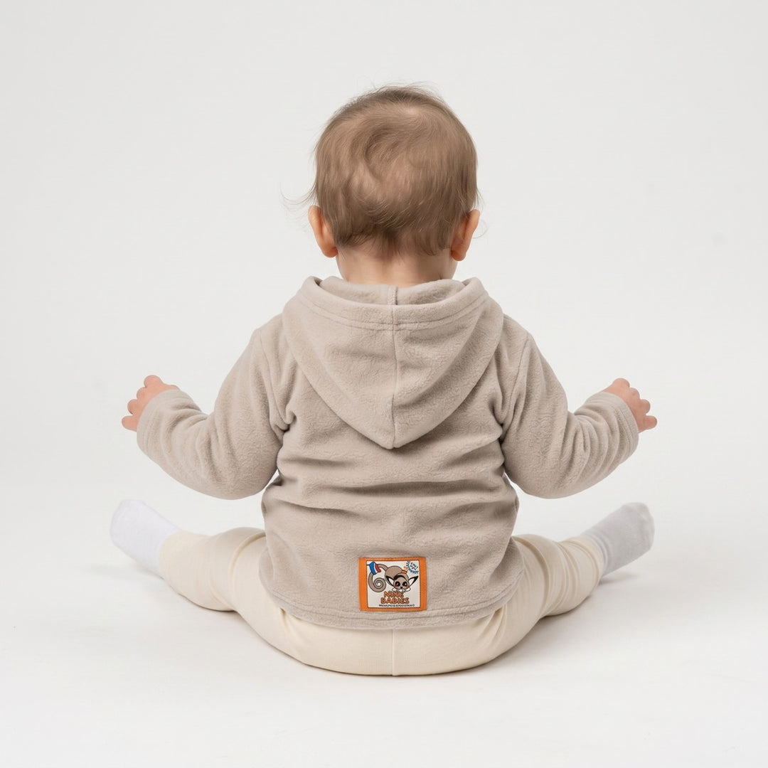 Stone beige fleece hoodie with a long-sleeved design, viewed from the back, featuring a distinctive penguin logo patch.