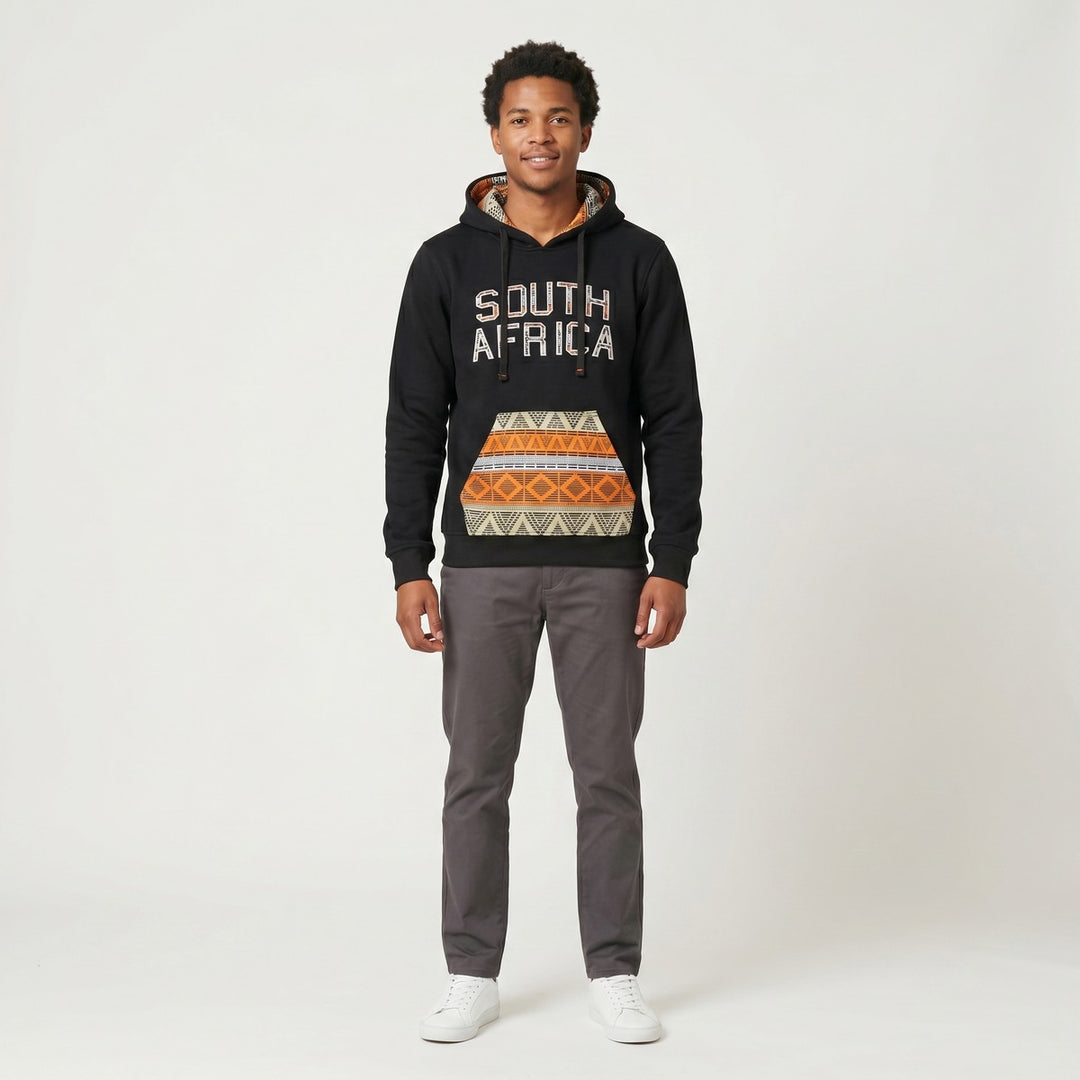 Black hoodie with 'SOUTH AFRICA' text and a vibrant orange, black, and white tribal pattern on the kangaroo pocket and hood
