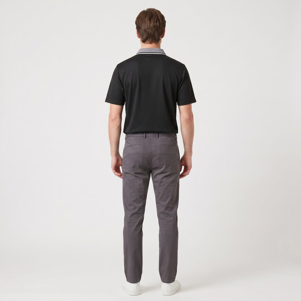 Rear view of a men's Golfer Big 5 Black short-sleeved polo shirt with a striped collar, worn tucked into grey trousers.