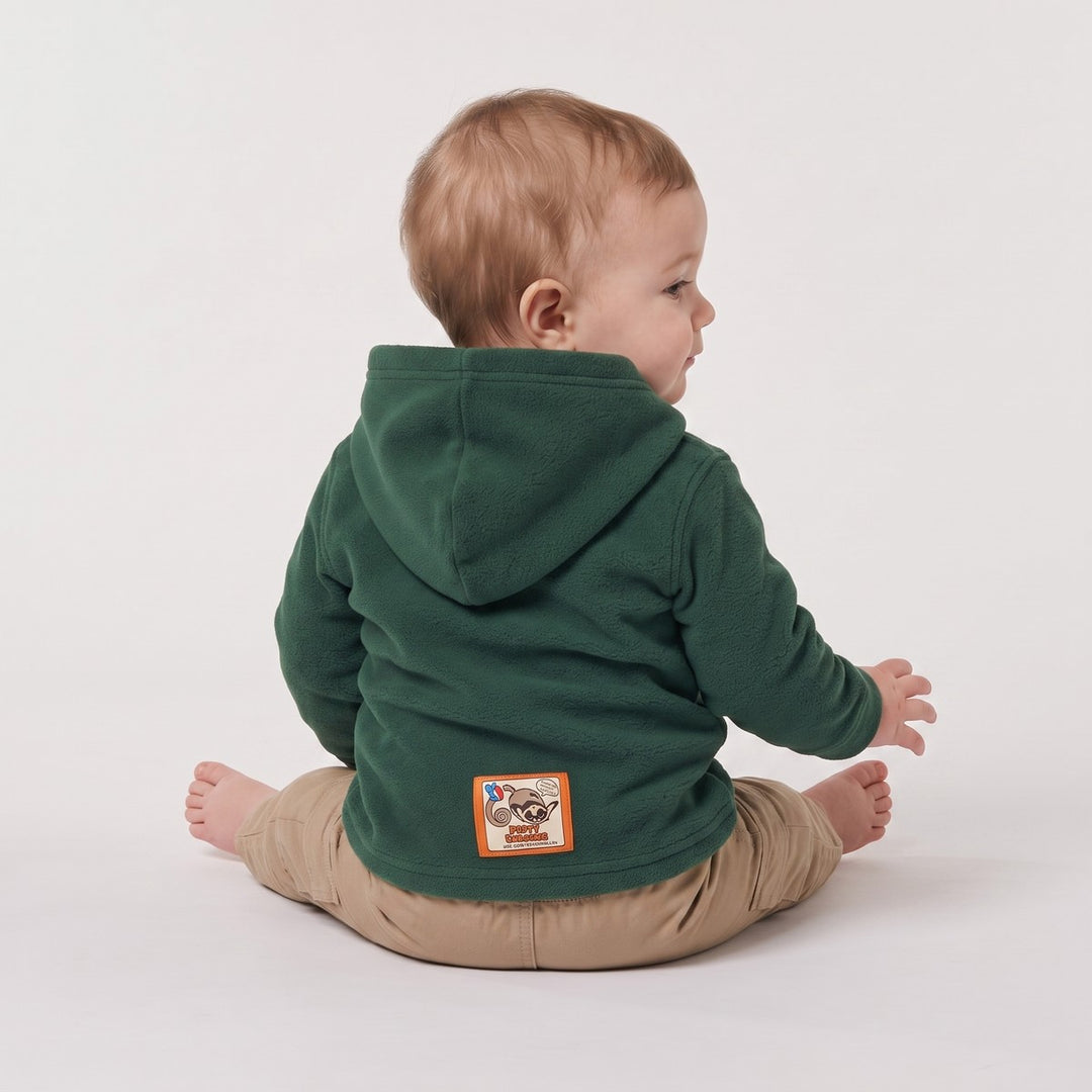 Child wearing a Springbok Bottle Green Hoodie. The dark green fleece hoodie features a colorful brand patch on the lower