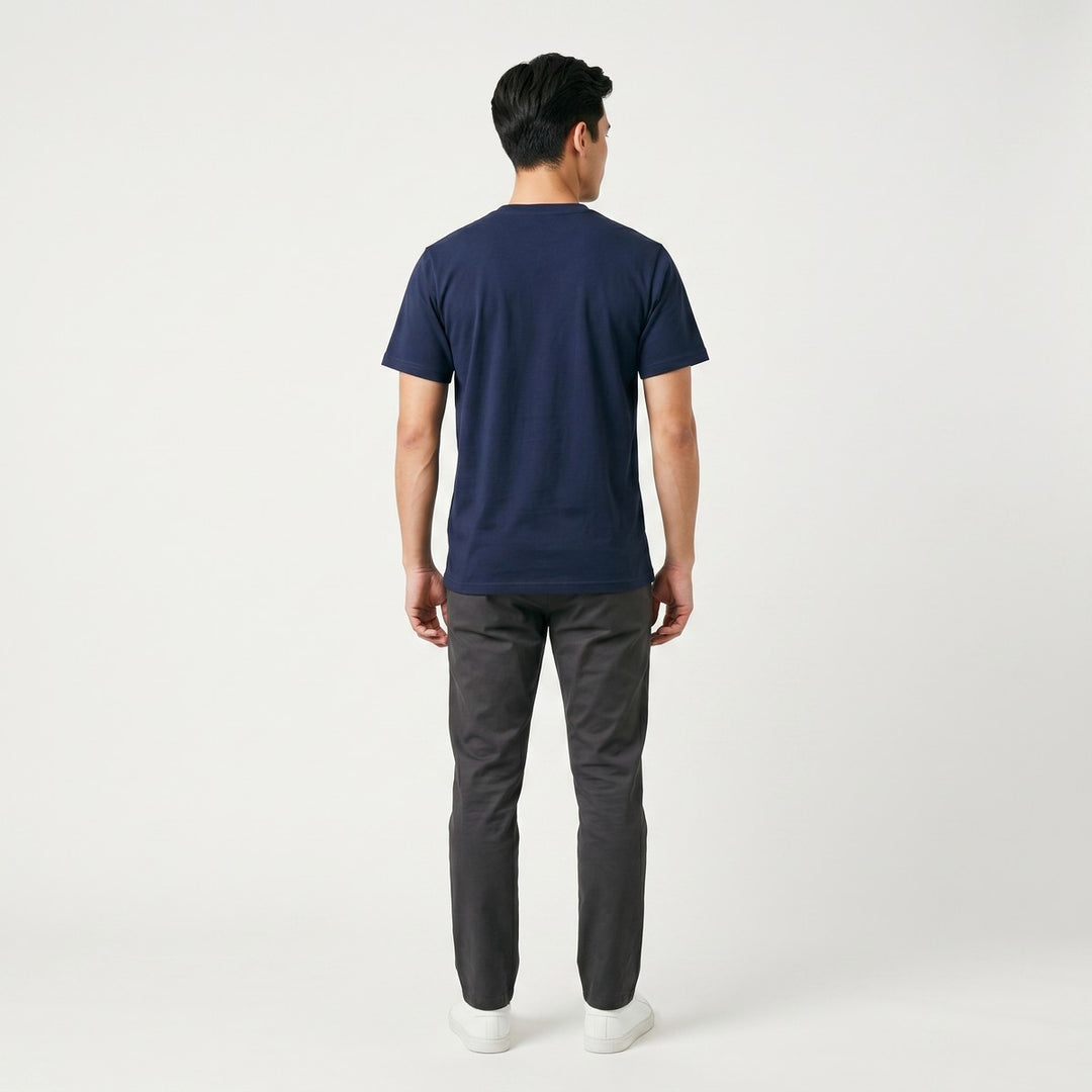 A plain navy blue Table Mountain T-Shirt, viewed from the back, neatly laid flat on a pristine white surface, ready for