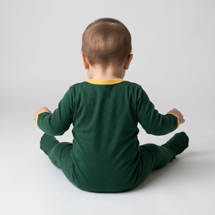 Dark green Winter Grower A-Line infant sleeper with yellow trim, featuring long sleeves and full-body coverage, shown from