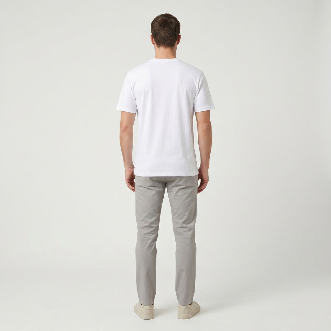 Back view of a plain white short-sleeve Word T-shirt made from a smooth cotton blend fabric, photographed on a table.