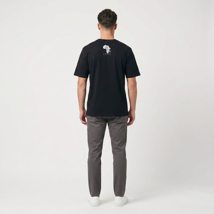 Back view of a black Zebra T-shirt, featuring a distinct white zebra-striped Africa map graphic on the upper back, laid flat.